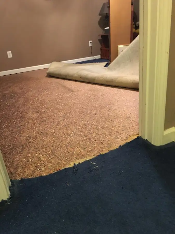 Carpet pad removal revealing water damage during Water Mitigation Services in Stockton